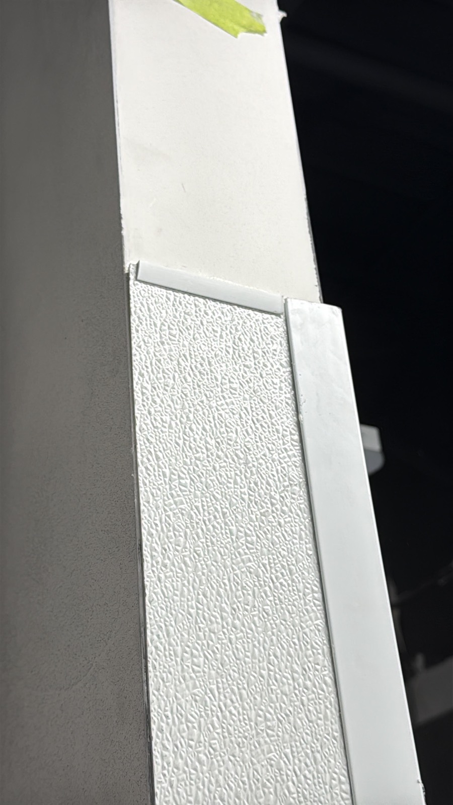 Close-up of textured FRP wall panel with division bar