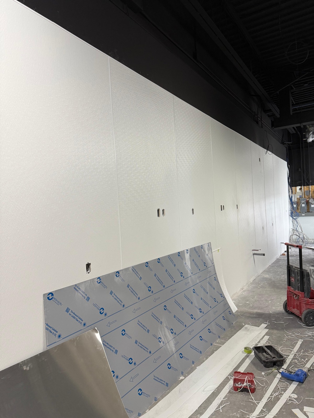 Long commercial wall finished with FRP panels and division bars